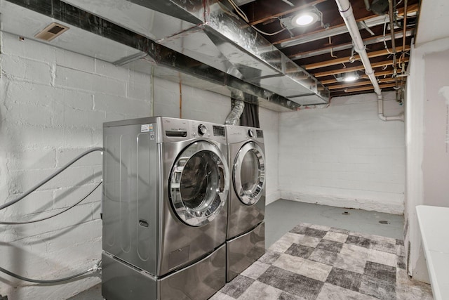 1148 Geranium Ave E, Saint Paul, MN 55106 - laundry room featuring washing machine and dryer and concrete block wall