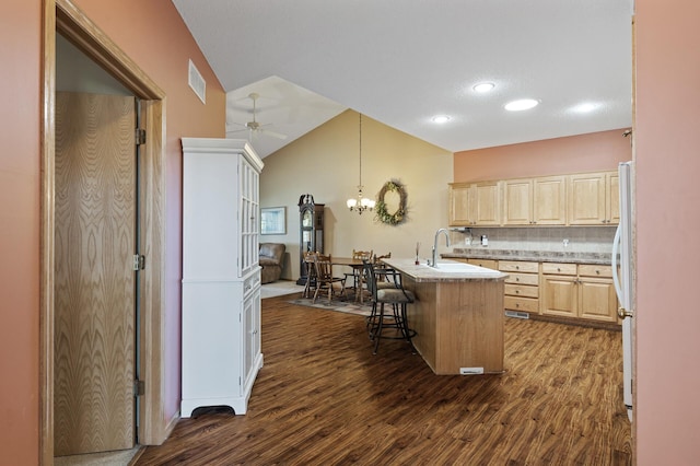 11645 Alpine Dr, Monticello, MN 55362 - kitchen featuring light brown cabinets, dark wood-style flooring, a kitchen breakfast bar, light countertops, and lofted ceiling