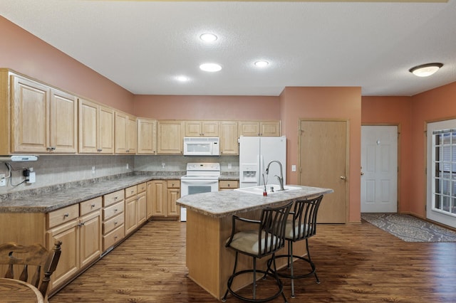 11645 Alpine Dr, Monticello, MN 55362 - kitchen featuring white appliances, wood finished floors, a sink, light brown cabinetry, and a textured ceiling