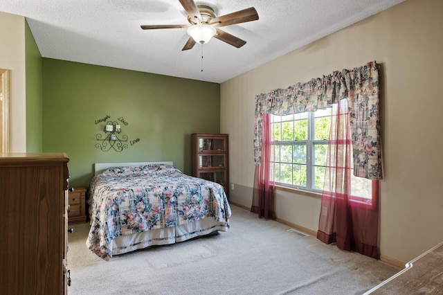 11645 Alpine Dr, Monticello, MN 55362 - bedroom with carpet, a textured ceiling, baseboards, and a ceiling fan