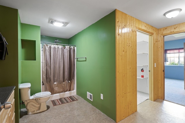 11645 Alpine Dr, Monticello, MN 55362 - bathroom featuring curtained shower, vanity, toilet, and wooden walls