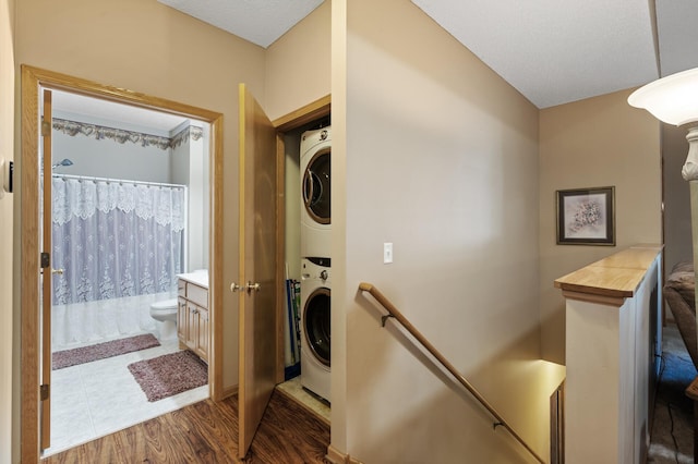 11645 Alpine Dr, Monticello, MN 55362 - washroom with estacked washer and dryer and wood finished floors