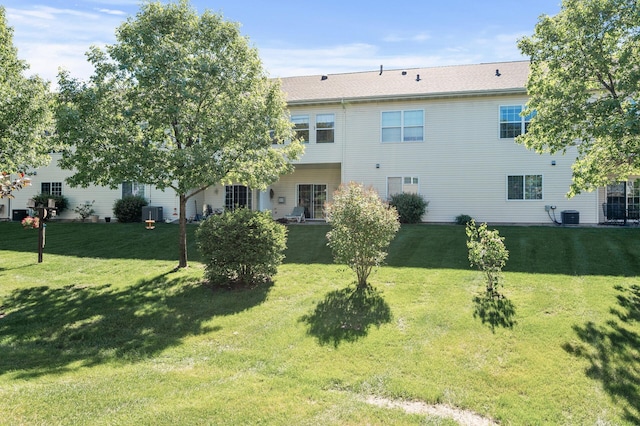 11645 Alpine Dr, Monticello, MN 55362 - rear view of house featuring a lawn and central air condition unit
