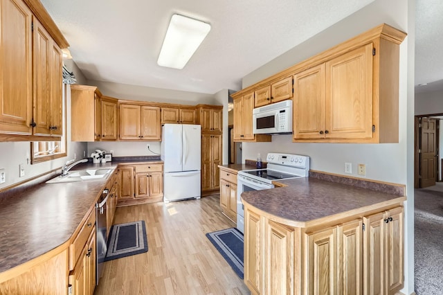 1110 Lia Ct, Northfield, MN 55057 - kitchen featuring dark countertops, white appliances, light wood-style flooring, and a peninsula
