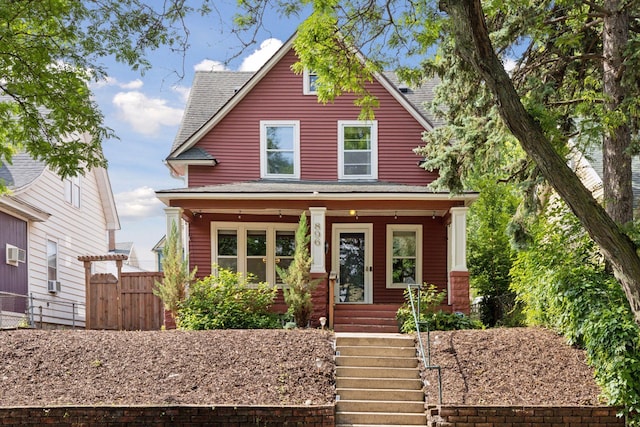 896 Carroll Ave, Saint Paul, MN 55104 - view of front of home with covered porch, a shingled roof, and stairway