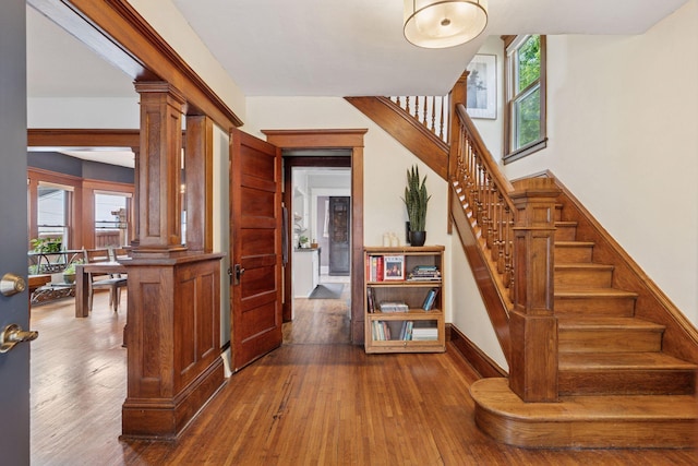 896 Carroll Ave, Saint Paul, MN 55104 - stairway with hardwood / wood-style flooring, healthy amount of natural light, and ornate columns