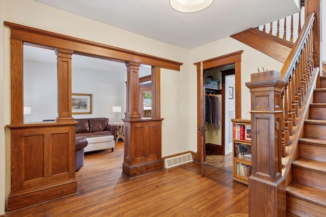 896 Carroll Ave, Saint Paul, MN 55104 - foyer featuring wood finished floors, stairway, and decorative columns