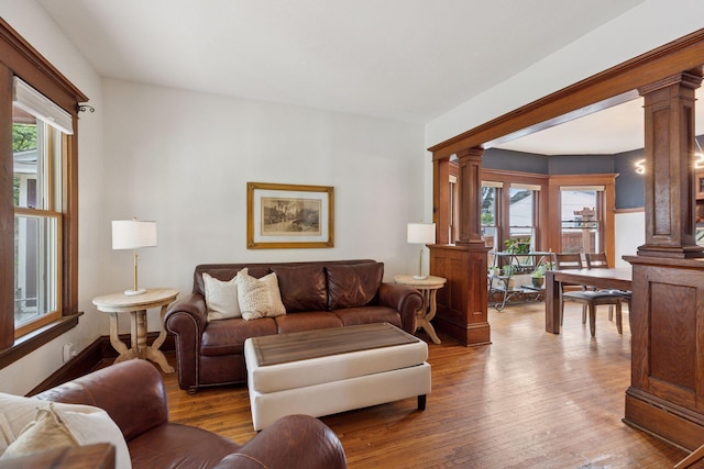 896 Carroll Ave, Saint Paul, MN 55104 - living area with ornate columns, healthy amount of natural light, and wood finished floors