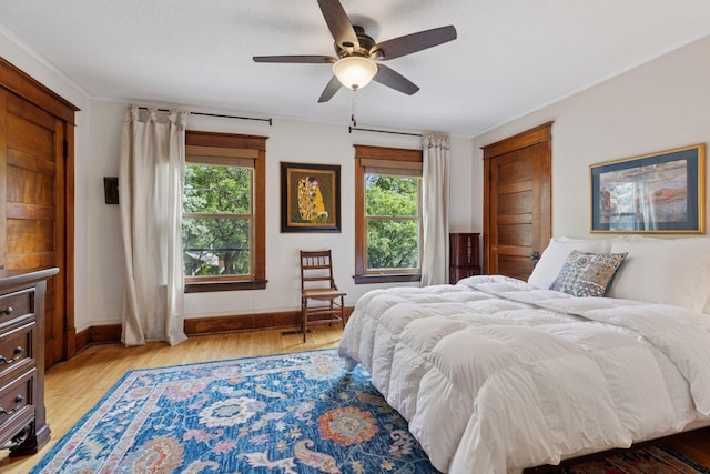 896 Carroll Ave, Saint Paul, MN 55104 - bedroom with multiple windows, light wood-type flooring, a ceiling fan, and ornamental molding