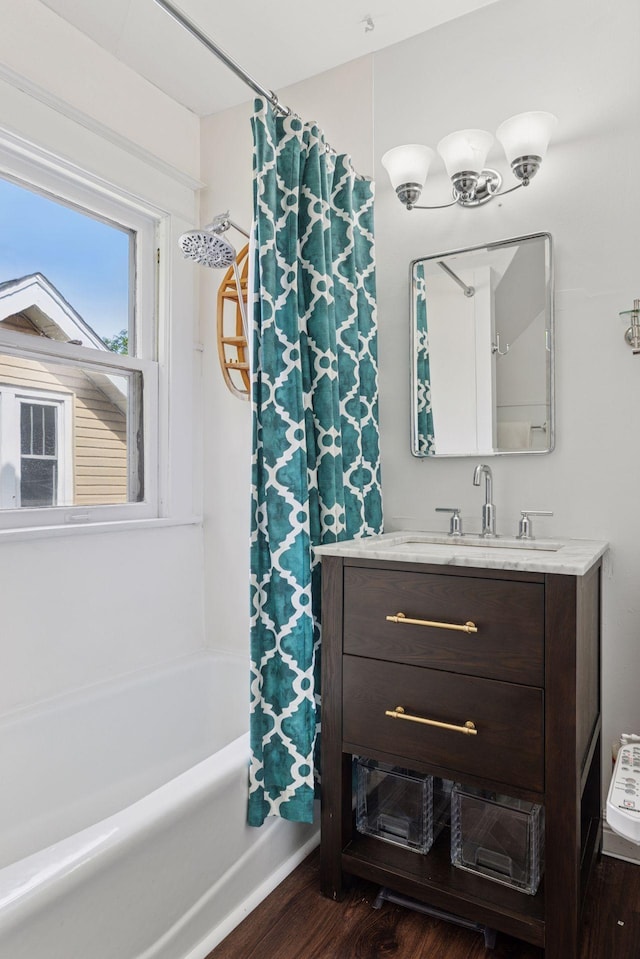 896 Carroll Ave, Saint Paul, MN 55104 - bathroom featuring vanity, wood finished floors, and shower / bathtub combination with curtain