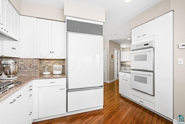 2900 London Rd, Duluth, MN 55804 - kitchen featuring white appliances, white cabinets, dark wood finished floors, decorative backsplash, and recessed lighting