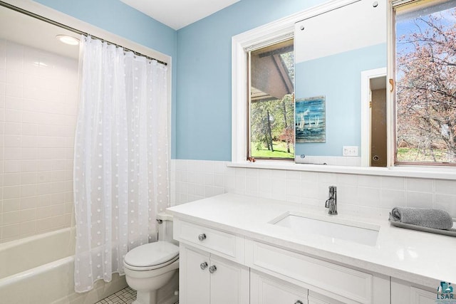 2900 London Rd, Duluth, MN 55804 - full bathroom with vanity, toilet, tile walls, shower / tub combo, and tile patterned floors