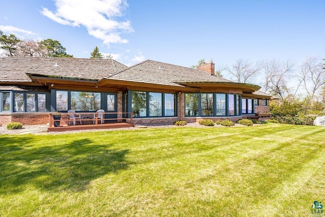 2900 London Rd, Duluth, MN 55804 - rear view of house with brick siding, a chimney, and a lawn