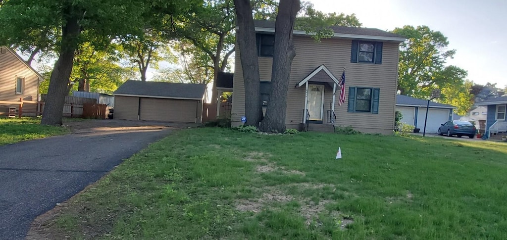 10414 Terrace Rd NE, Blaine, MN 55434 - traditional-style home with a detached garage, a front yard, and an outbuilding
