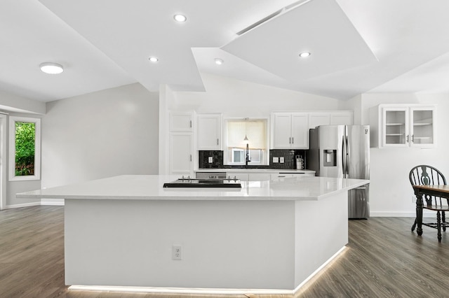 2035 123rd Ave NW, Coon Rapids, MN 55448 - kitchen with stainless steel fridge with ice dispenser, white cabinetry, decorative backsplash, cooktop, and dark wood finished floors
