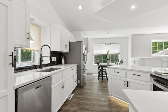 2035 123rd Ave NW, Coon Rapids, MN 55448 - kitchen featuring appliances with stainless steel finishes, a sink, a chandelier, white cabinetry, and dark wood finished floors