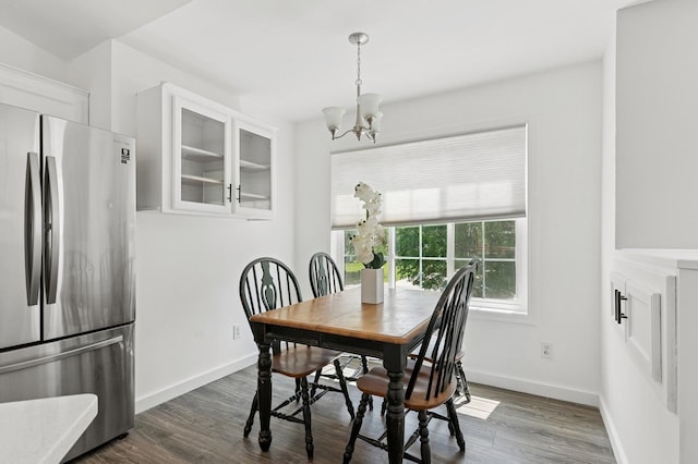 2035 123rd Ave NW, Coon Rapids, MN 55448 - dining space with a chandelier, dark wood-style floors, and baseboards