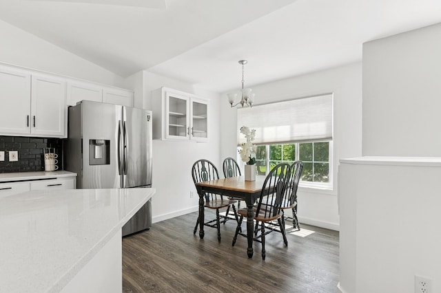 2035 123rd Ave NW, Coon Rapids, MN 55448 - dining area featuring a chandelier, dark wood-style flooring, baseboards, and lofted ceiling