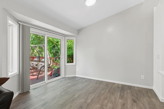 2035 123rd Ave NW, Coon Rapids, MN 55448 - unfurnished room featuring wood finished floors and baseboards