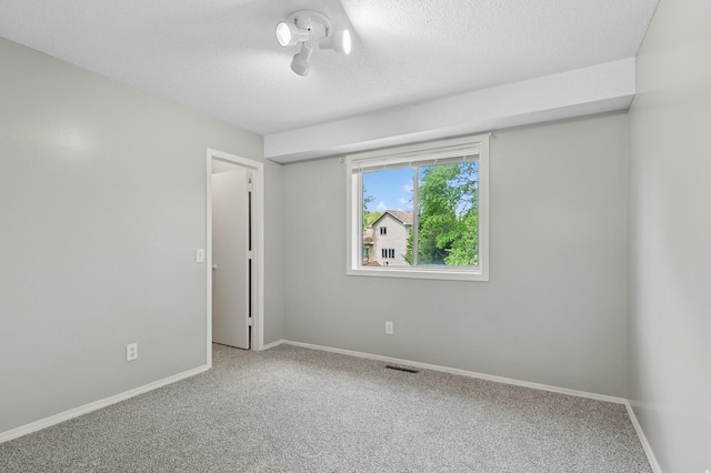 2035 123rd Ave NW, Coon Rapids, MN 55448 - carpeted spare room featuring a textured ceiling and baseboards
