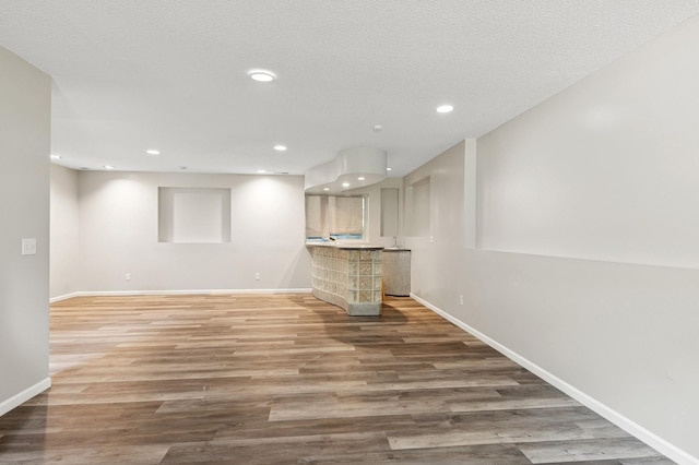 2035 123rd Ave NW, Coon Rapids, MN 55448 - finished basement with wood finished floors, baseboards, recessed lighting, and bar area