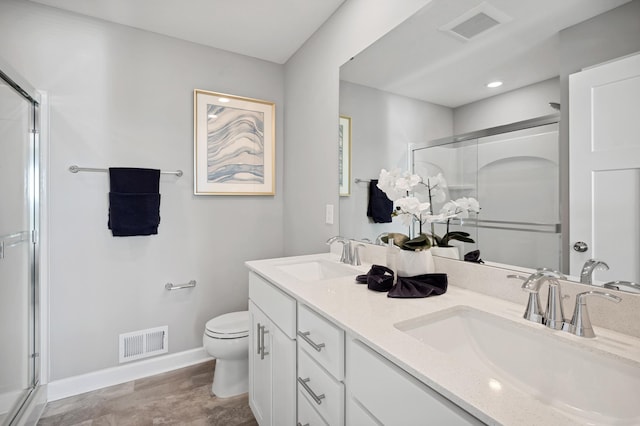 21749 Lilac Dr, Farmington, MN 55024 - bathroom with a stall shower, toilet, baseboards, double vanity, and wood finished floors