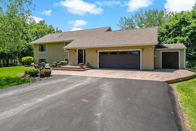 21570 France Blvd, Credit River Twp, MN 55044 - split level home featuring a garage, driveway, roof with shingles, and a front lawn
