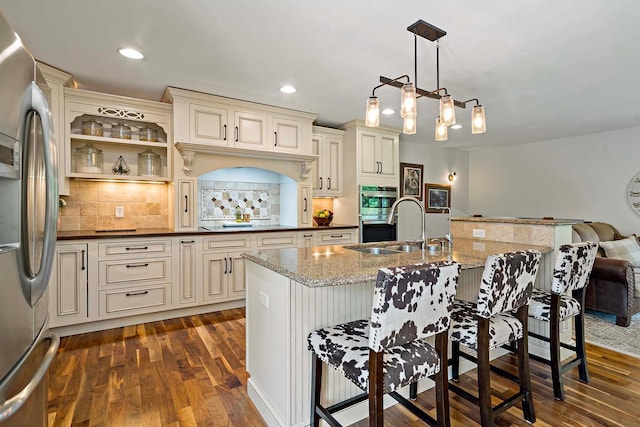 21570 France Blvd, Credit River Twp, MN 55044 - kitchen with appliances with stainless steel finishes, cream cabinets, a sink, dark wood-style floors, and recessed lighting