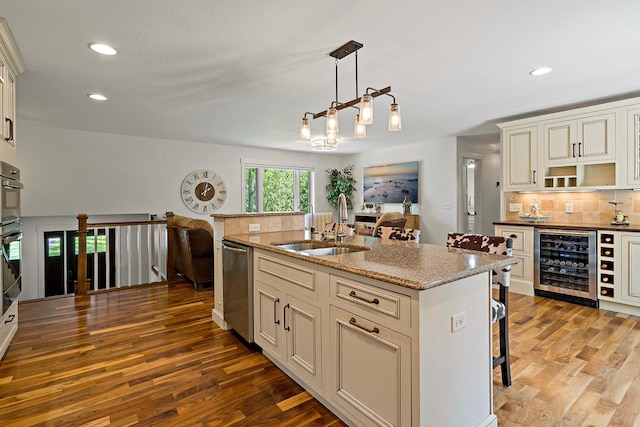 21570 France Blvd, Credit River Twp, MN 55044 - kitchen with beverage cooler, dishwasher, a sink, wood finished floors, and recessed lighting