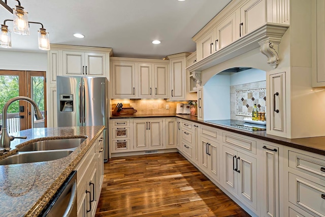 21570 France Blvd, Credit River Twp, MN 55044 - kitchen with a sink, cream cabinetry, dark wood-style flooring, dark stone counters, and recessed lighting