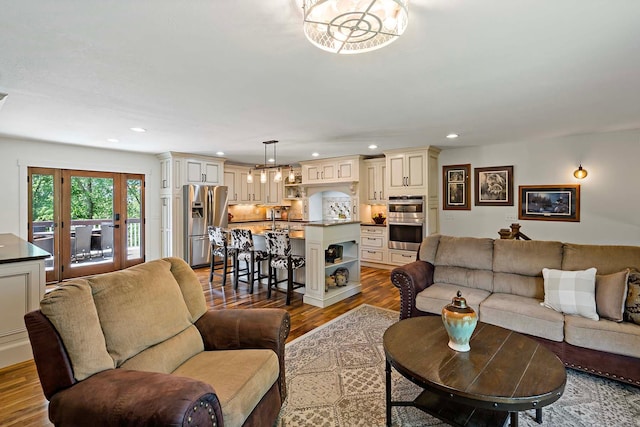 21570 France Blvd, Credit River Twp, MN 55044 - living area featuring wood finished floors, recessed lighting, and a chandelier