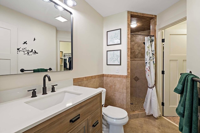 21570 France Blvd, Credit River Twp, MN 55044 - full bathroom with a tile shower, tile patterned flooring, vanity, toilet, and tile walls