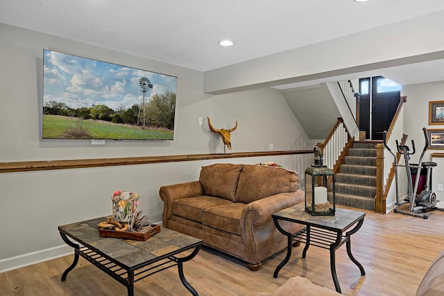 21570 France Blvd, Credit River Twp, MN 55044 - living area featuring wood finished floors, baseboards, recessed lighting, and stairway