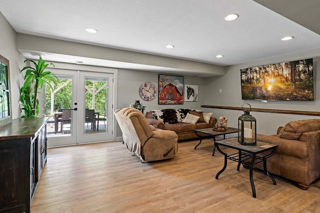 21570 France Blvd, Credit River Twp, MN 55044 - living room with light wood-style flooring, recessed lighting, a textured ceiling, and french doors