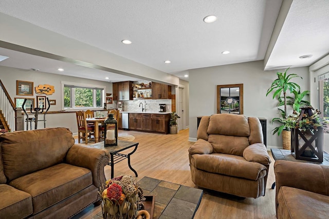21570 France Blvd, Credit River Twp, MN 55044 - living room with stairs, plenty of natural light, light wood-type flooring, recessed lighting, and a textured ceiling