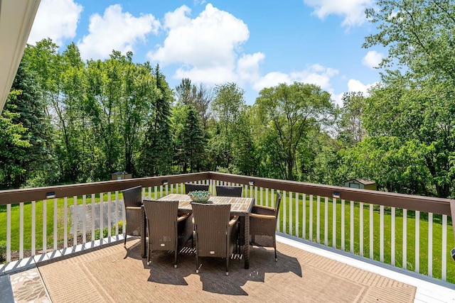 21570 France Blvd, Credit River Twp, MN 55044 - wooden deck featuring outdoor dining area and a lawn