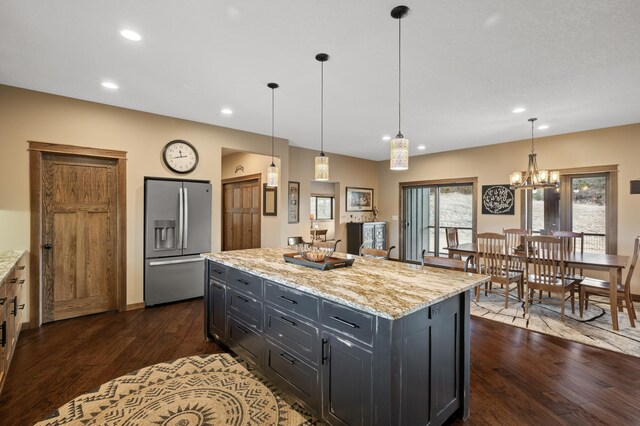 8530 Fir St, Greenfield, MN 55373 - kitchen featuring stainless steel refrigerator with ice dispenser, dark wood-style flooring, recessed lighting, light stone counters, and a chandelier