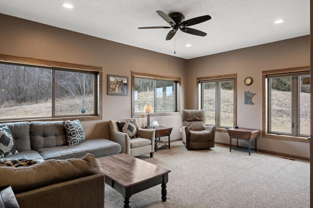 8530 Fir St, Greenfield, MN 55373 - living room with light carpet, baseboards, recessed lighting, ceiling fan, and a textured ceiling
