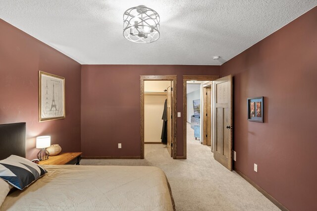 8530 Fir St, Greenfield, MN 55373 - bedroom with carpet flooring, a textured ceiling, a spacious closet, and baseboards