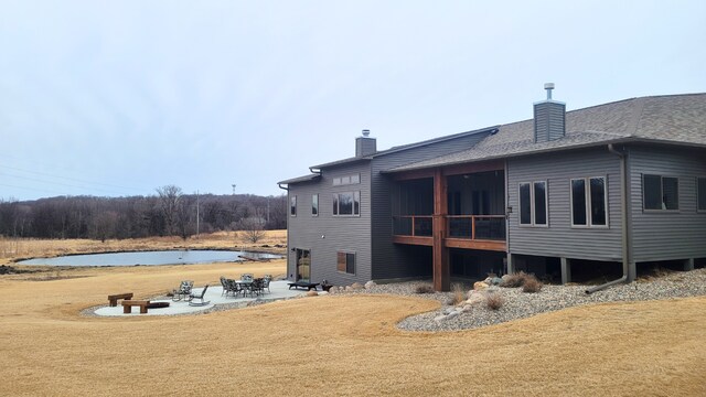 8530 Fir St, Greenfield, MN 55373 - back of house featuring a chimney, a patio area, and a shingled roof