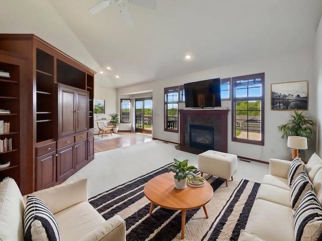 1101 Golfers Ct SE, Rochester, MN 55904 - living area featuring vaulted ceiling, plenty of natural light, a glass covered fireplace, recessed lighting, and ceiling fan