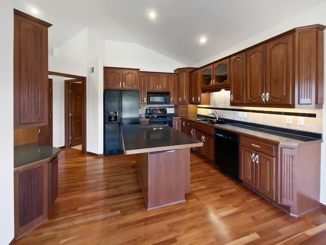1101 Golfers Ct SE, Rochester, MN 55904 - kitchen featuring black appliances, a sink, tasteful backsplash, vaulted ceiling, and light wood finished floors