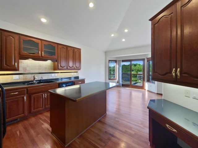 1101 Golfers Ct SE, Rochester, MN 55904 - kitchen featuring a sink, lofted ceiling, decorative backsplash, a center island, and dark countertops