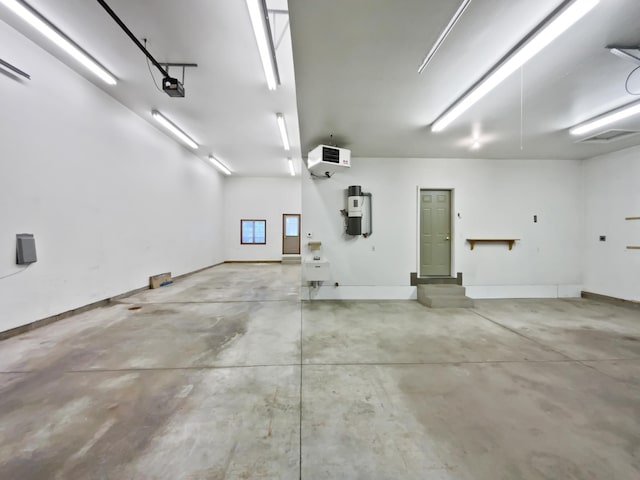 1101 Golfers Ct SE, Rochester, MN 55904 - garage with a central vacuum unit, a garage door opener, a heating unit, and baseboards