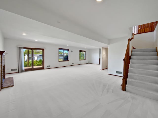 1101 Golfers Ct SE, Rochester, MN 55904 - unfurnished living room featuring recessed lighting, stairway, light colored carpet, and baseboards
