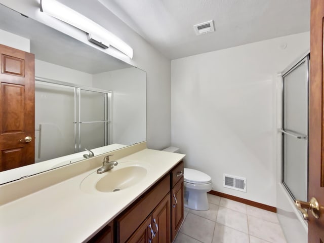 1101 Golfers Ct SE, Rochester, MN 55904 - bathroom with vanity, toilet, baseboards, tile patterned flooring, and bath / shower combo with glass door