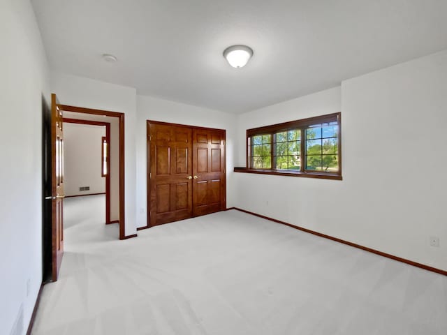 1101 Golfers Ct SE, Rochester, MN 55904 - unfurnished bedroom featuring light colored carpet, a closet, and baseboards