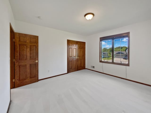 1101 Golfers Ct SE, Rochester, MN 55904 - unfurnished bedroom featuring baseboards, light colored carpet, and a closet