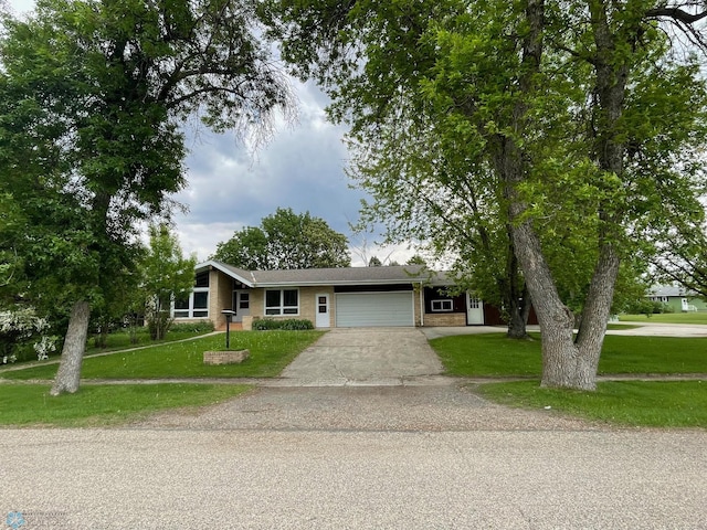103 4th St S, Fairmount, ND 58030 - view of front of home featuring an attached garage, driveway, a front yard, and brick siding