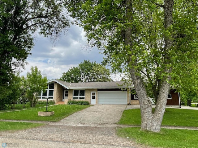 103 4th St S, Fairmount, ND 58030 - mid-century inspired home with an attached garage, a front lawn, driveway, and brick siding